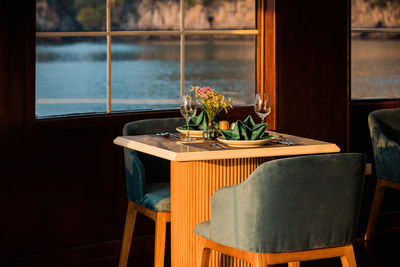 Potted plant on table by window