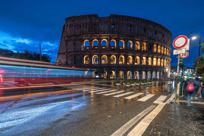 Traffic in colosseum at night. rome, italy