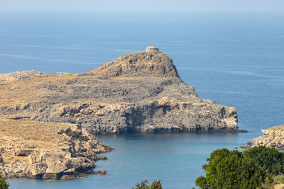 View at a bay in lindos with rocky coastline on greek island rhodes on a sunny day in spring