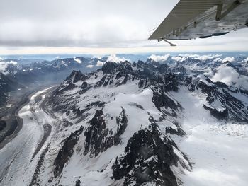 Aerial view of snowcapped mountains against sky