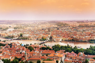 High angle view of townscape and river against sky