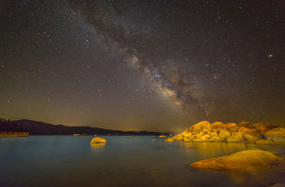 Scenic view of river against star field at night