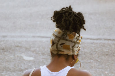 Rear view of woman wearing mask on beach