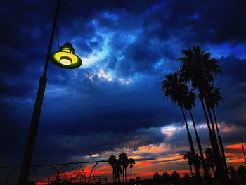 Low angle view of street light against cloudy sky