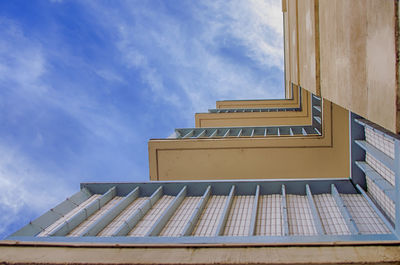 Low angle view of building against cloudy sky