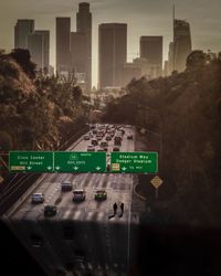 Information sign on road by buildings in city