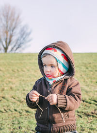 Full length of cute girl standing on field