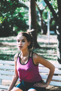 Portrait of young woman sitting outdoors