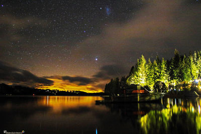 Scenic view of lake against sky at night