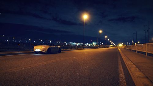 Cars on illuminated street at night