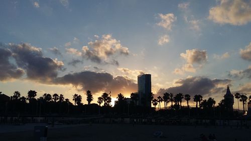 Panoramic view of silhouette city against sky during sunset