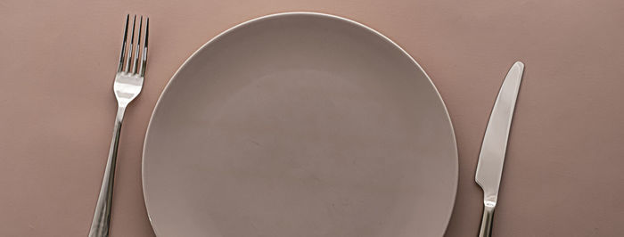 Close-up of empty plate against white background