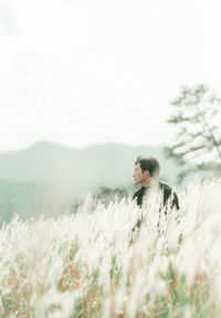 Portrait of man standing in the middle of white reeds