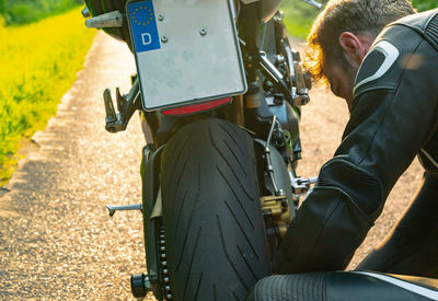 Side view of two men sitting on road