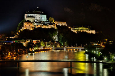Illuminated kufstein fortress against sky at night