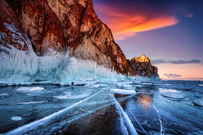 Scenic view of frozen sea against sky during sunset