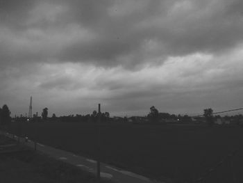 Road by buildings in city against sky