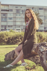 Portrait of young woman sitting outdoors