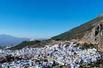 Panoramic shot of townscape against clear blue sky