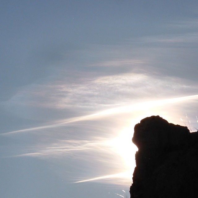 scenics, sky, tranquil scene, tranquility, beauty in nature, sunset, nature, rock - object, cloud - sky, rock formation, idyllic, silhouette, sunlight, cloud, sun, outdoors, mountain, non-urban scene, sea, sunbeam