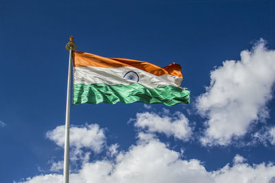 Low angle view of indian flag against blue sky during sunny day