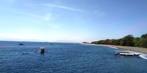 Boats in sea against sky