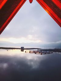 Bridge over river against sky during sunset