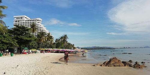 People on beach against sky