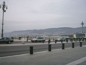 Cars on beach against sky