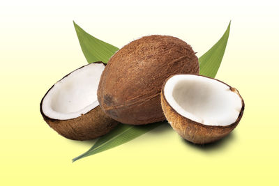 Close-up of banana and leaves against white background