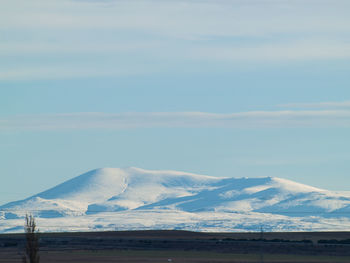 Scenic view of snow covered mountains against sky