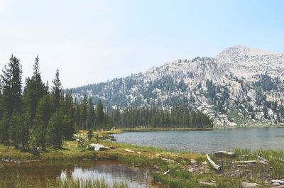 Scenic view of lake and mountains against clear sky