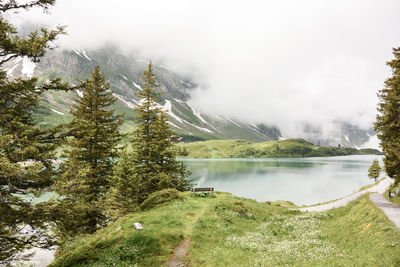 Scenic view of lake and mountains against sky