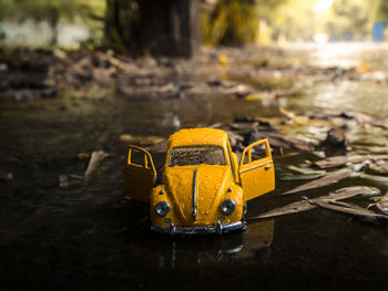 Close-up of yellow toy car on land