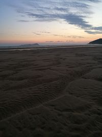 Scenic view of beach at sunset