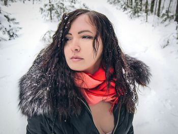 Young woman wearing winter coat on snowy field