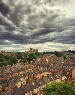 Cityscape against cloudy sky
