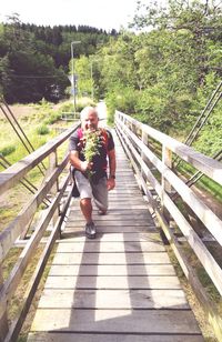 Full length of man on footbridge