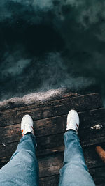 Low section of man legs on wood