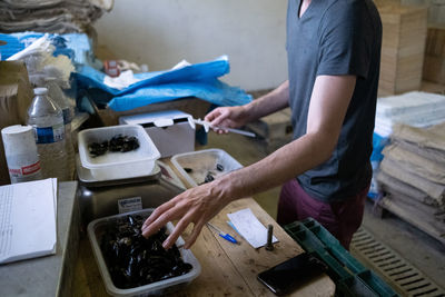 Midsection of man working on table