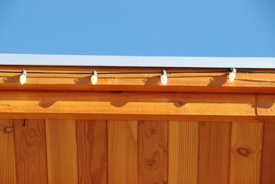 Low angle view of yellow wooden structure against clear sky