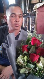 Portrait of man with flower bouquet