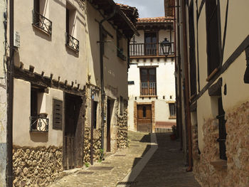 Narrow alley amidst old buildings in town