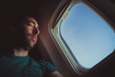 Portrait of young man in airplane