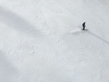 High angle view of person skiing on snow covered field