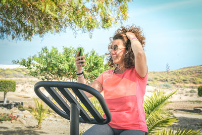 Woman listening to music while exercising on exercise bike