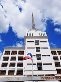 Low angle view of flag on building against sky