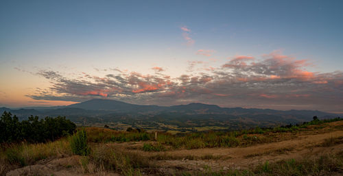 Scenic view of field against sky during sunset