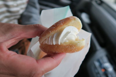 Close-up of woman holding cream puff