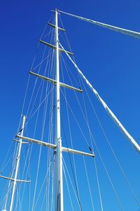 Low angle view of sailboat against blue sky